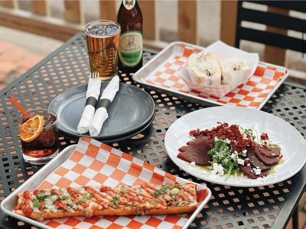 Patio table at Spoko with zapiekanka, beet salad, Polish beer and a negroni, Lincoln Park Chicago
