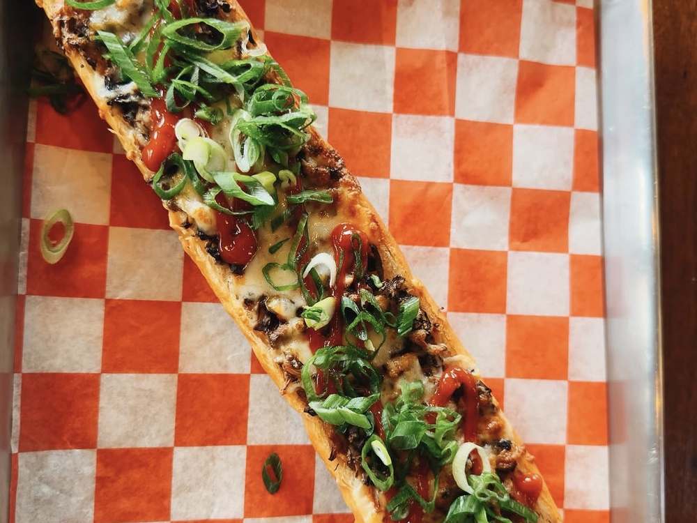 Classic zapiekanka with mushrooms, melted cheese, green onions and ketchup at Spoko Chicago